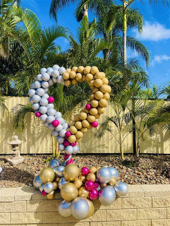 Silver, gold and pink heart-shaped balloon column